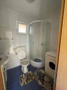 a bathroom with a shower and a toilet and a sink at sunny Podaca in Podaca +30 photos