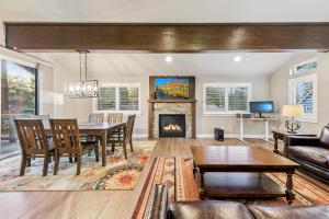 a living room with a table and a fireplace at Chalet Near The Tahoe Keys in South Lake Tahoe +28 photos