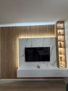 a living room with a flat screen tv on a wall at Cozy Pogradec up in Pogradec