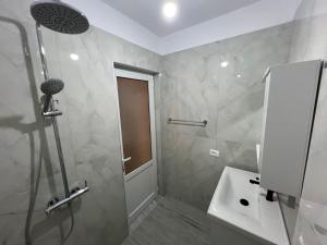 a bathroom with a shower and a sink at Cozy Pogradec up in Pogradec +17 photos