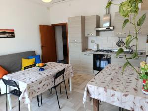 a kitchen and dining room with a table and chairs at Appartamenti Sole&Mare in Marotta