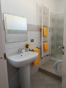 a white bathroom with a sink and a shower at Appartamenti Sole&Mare in Marotta