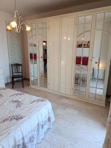 a bedroom with a bed and a large mirror at Appartamenti Sole&Mare in Marotta +5 photos