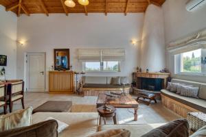 a living room with a couch and a fireplace at Villa John Dimeon Kato Achaia With Pool - Happy Rentals in Patra