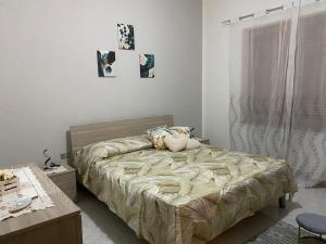 a bedroom with a bed with a pillow on it at HolidayHomePalma in Santa Maria