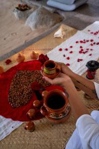 a person holding a cup of coffee on a table at Mision del Sol Resort & Spa Adults Only in Cuernavaca