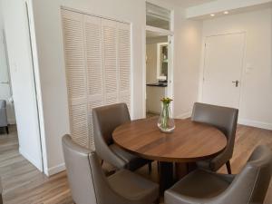 a dining room with a wooden table and chairs at Premier Downtown Koreatown Apartment in Los Angeles +14 photos