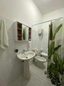 a white bathroom with a sink and a toilet at HolidayHomePalma in Santa Maria +39 photos