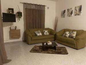 a living room with two couches and a coffee table at HolidayHomePalma in Santa Maria
