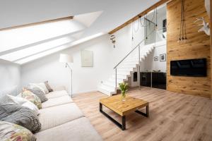 a living room with a couch and a table at Kopernik Loft Jelenia Góra in Jelenia Góra