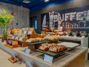 a buffet with many different types of food on display at ibis budget Santos Gonzaga in Santos