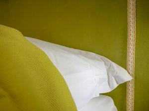 A bed or beds in a room at Casa Isolani Luxury Rooms Piazza Maggiore 1