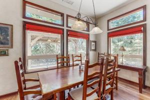 a dining room with a wooden table and chairs at Summit Sanctuary in Lake Arrowhead