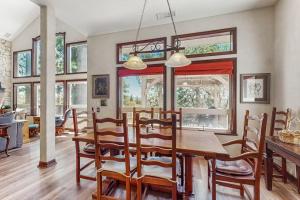 a dining room with a wooden table and chairs at Summit Sanctuary in Lake Arrowhead +20 photos