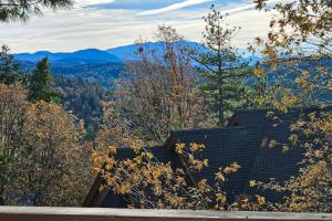 a roof of a house with mountains in the background at Summit Sanctuary in Lake Arrowhead