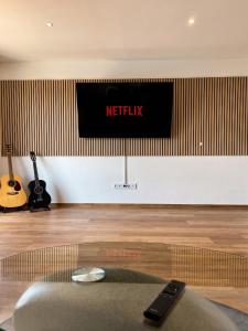 a netflix sign on a wall in a room at Deluxe Apartment in Jettingen-Scheppach