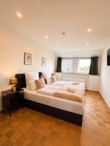 a bedroom with a large bed in a room at Deluxe Apartment in Jettingen-Scheppach +5 photos