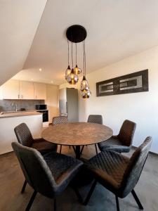 a kitchen and dining room with a table and chairs at Deluxe Apartment in Jettingen-Scheppach