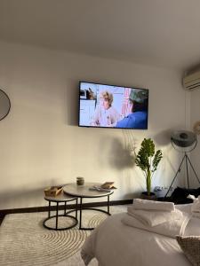 a living room with a tv on a wall at Paula suite avec terrasse-Croisette, Plage Festival Palais in Cannes