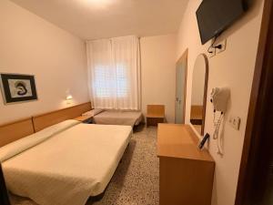 a hospital room with two beds and a phone at Hotel Anny in Cervia