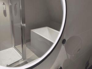a bathroom with a shower and a mirror at Mercure Paris 17 Batignolles in Paris