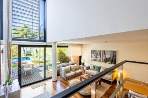 an open living room with a view of a pool at Troia Ocean Breeze Villa in Troia