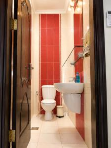 a bathroom with a toilet and a sink at Cozy Central Secured Compound in Amman
