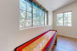 a room with a pool table in front of two windows at Lake Gregory Escape in Crestline