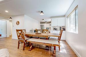 a kitchen and dining room with a wooden table and chairs at Lake Gregory Escape in Crestline +19 photos