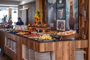 a buffet line with many different types of food at Casa Andora in Machu Picchu