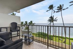 a balcony with a view of the ocean at Luxury Beachfront Condo in Hauula