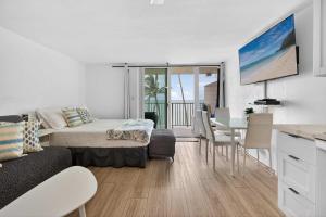 a living room with a couch and a table at Luxury Beachfront Condo in Hauula