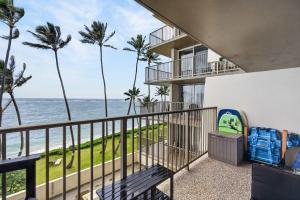 a balcony with a view of the ocean at Luxury Beachfront Condo in Hauula