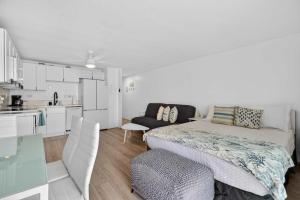 a small bedroom with a bed and a kitchen at Luxury Beachfront Condo in Hauula +61 photos