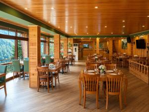 a restaurant with wooden floors and tables and chairs at Ayder Doga Resort in Ayder Yaylasi