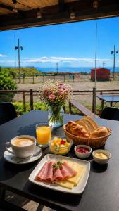 a table with a plate of food and bread and drinks at Luxury Private Garden Home in Ojos de Garza
