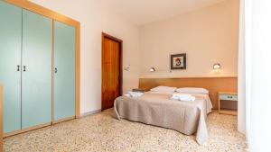 a hotel room with a bed and a closet at Hotel Anny in Cervia +58 photos