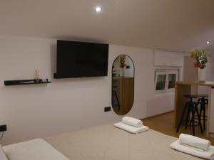 a living room with a flat screen tv on the wall at Rentalica in Belgrade