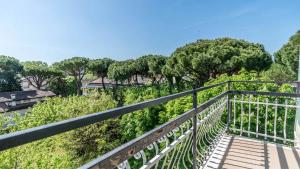 a metal walkway with trees in the background at Hotel Anny in Cervia