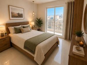 a bedroom with a large bed and a large window at Luna Suites in St. Julianʼs