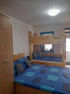 a bedroom with a bunk bed with a blue floor at Casa de vacanta Amira in Sfântu Gheorghe