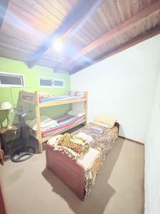 a bedroom with a bed in a room with a ceiling at Los Nardos in San Nicolás de los Arroyos