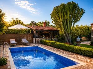 a swimming pool in the backyard of a house at Villa Elysian Private pool & garden view in Antimácheia