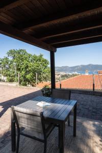 a wooden table and a chair on a patio at Aethalia Bed and Breakfast in Portoferraio