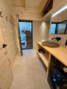 a bathroom with a sink and a washing machine at Steinberghaus am Rofan in Steinberg am Rofan