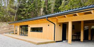 a wooden house with a large wooden deck at Steinberghaus am Rofan in Steinberg am Rofan +8 photos