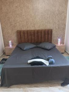 a bed with two towels and two candles on it at Maison ras angela in Bizerte
