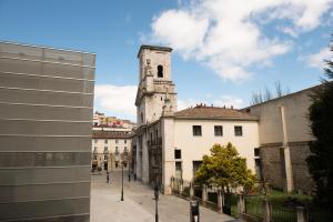an old building with a clock tower in a city at B&H Boreal in Burgos +26 photos