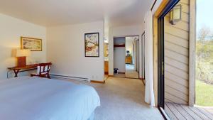 a bedroom with a bed and a desk and a hallway at Ridge Condo 2610 in Sun Valley +25 photos