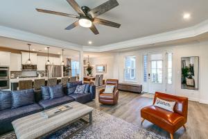 a living room with a couch and a ceiling fan at Beach Shuttle! Spacious Bishop’s Landing Retreat in Ocean View